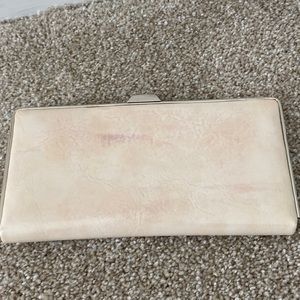 Slim. Wallet holds credit cards & money. slightly discolored. Off White/Cream
